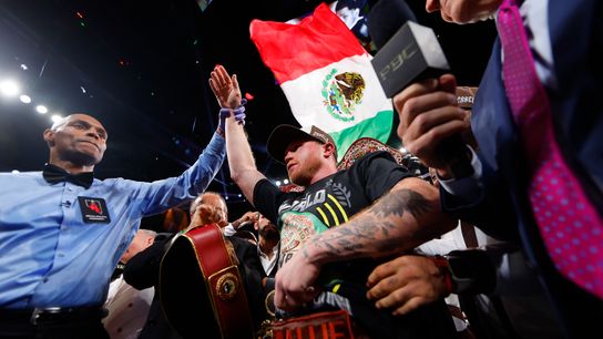 Referee Harvey Dock raises Canelo Alvarez's hand after he scored a unanimous decision Saturday over Edgar Berlanga at T-Mobile Arena in Las Vegas.