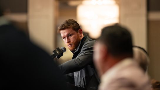 Canelo Alvarez glares at Oscar De La Hoya (foreground) as he makes comments during the news conference Wednesday at the MGM Grand in Las Vegas to promote his fight against Jaime Munguia on Saturday.