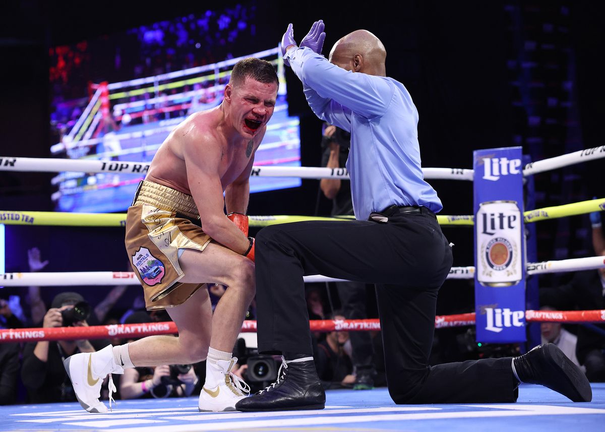 Referee Harvey Dock reaches the count of 10 as Denys Berinchyk winces from a Keyshawn Davis body shot.