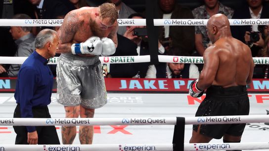 Jake Paul (L) bows in a sign of respect to opponent Mike Tyson.