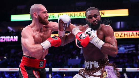 Karen Chukhadzhian (L) follows through after landing a left on Jaron Ennis Saturday in their IBF welterweight title bout.