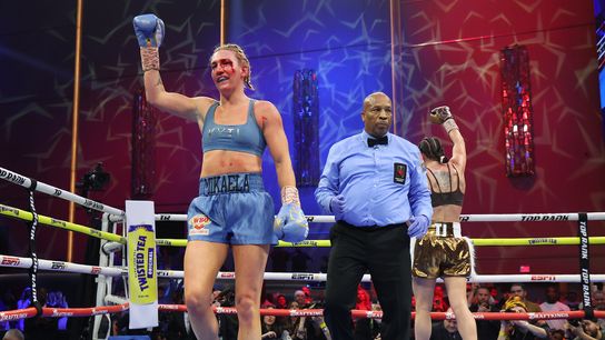 Mikaela Mayer (blue) raises his arm in a token of victory after her bout Saturday with Sandy Ryan in Las Vegas. Mayer retained her WBO welterweight title via unanimous decision.