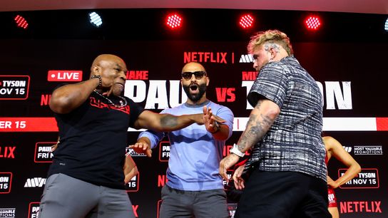 Mike Tyson and Jake Paul pose with promoter Nakisa Bidarian.