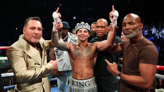 Promoters Oscar De La Hoya (L) and Bernard Hopkins (R) celebrate Ryan Garcia's majority decision victory over Devin Haney Saturday in Brooklyn.