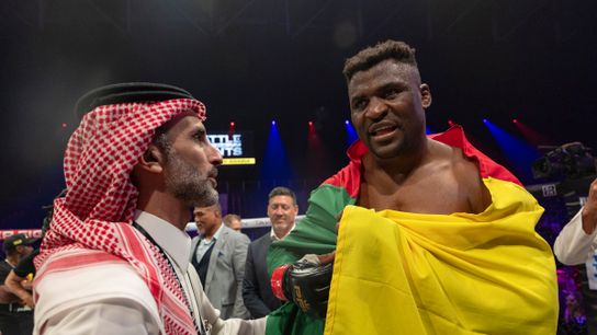 Francis Ngannou (R) celebrates his first-round TKO victory over Renan Ferreira.